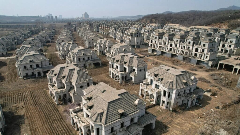 Row of abandoned villas in a ghost town, showcasing fragile urban decay