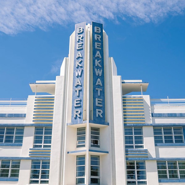 A pastel-colored Art Deco building with geometric windows and stylized facade in South Beach, Miami