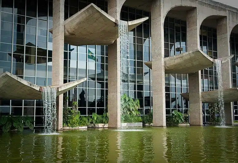 National Congress building in Brasília, featuring its iconic twin domes and vertical legislative towers in modernist style.