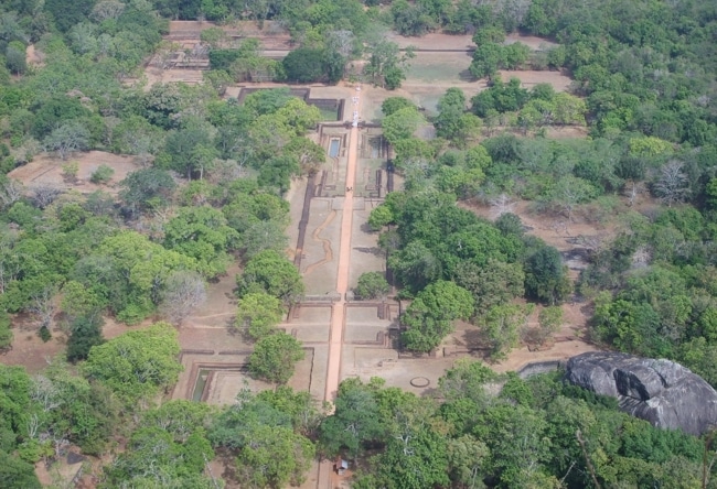 Aerial shot capturing winding channels and visible fountain structures within the water gardens.