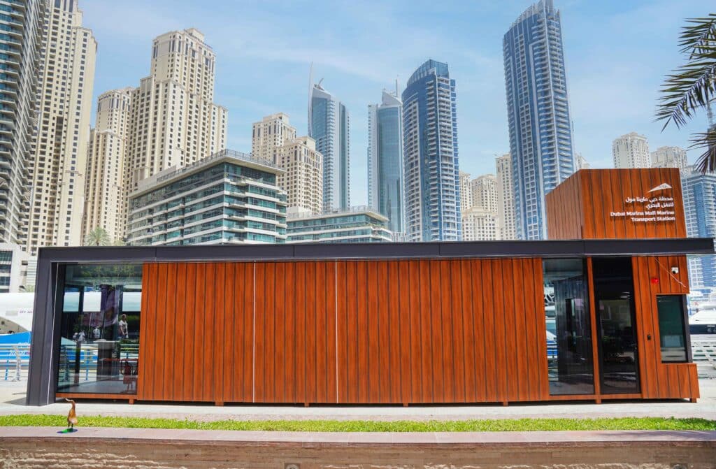 Phase II marine transport station upgrade in Dubai Marina, set against a backdrop of skyscrapers.