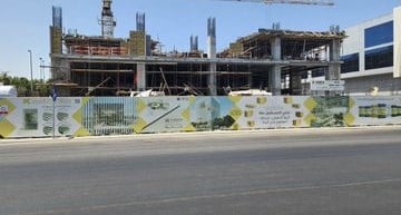 Architectural rendering of Al-Khayyat Plaza Tower with transparent glass fa&ccedil;ades and internal green terraces