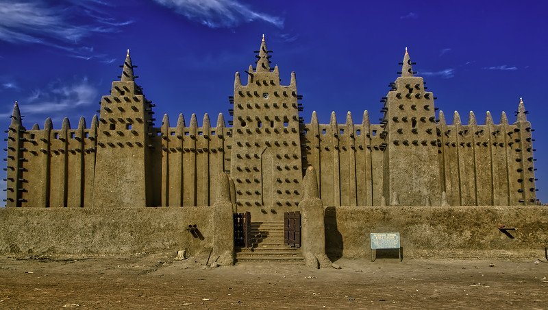 The Great Mosque of Djenn&eacute; beneath a clear blue sky, highlighting its natural earthen tones