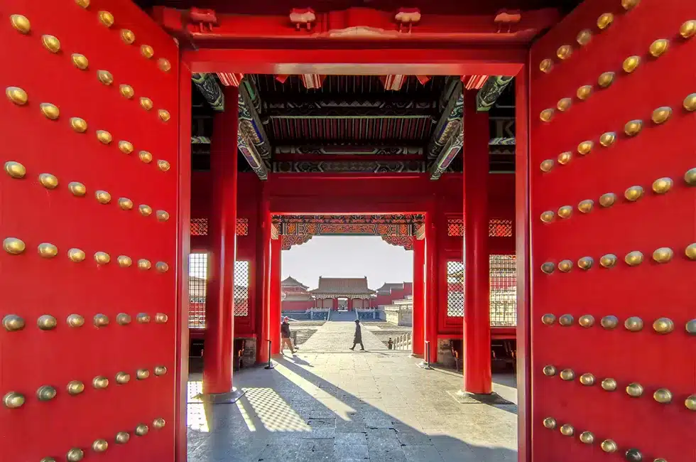 Interior of an imperial hall decorated with golden motifs, columns, and traditional roof beams