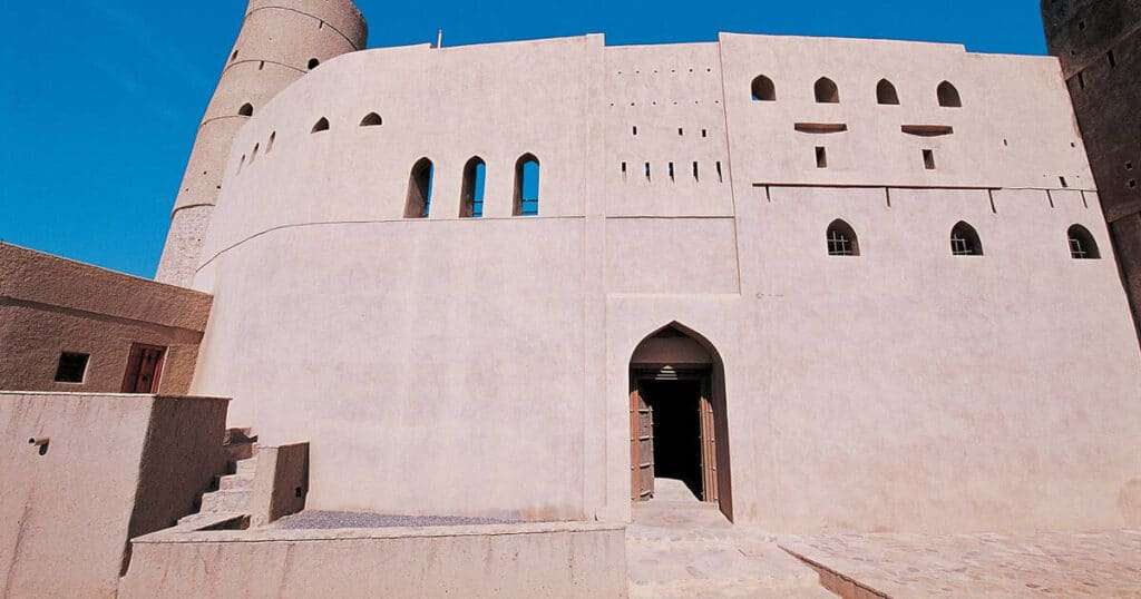 Nakhal Fort perched atop a rocky hill, surrounded by lush date palms