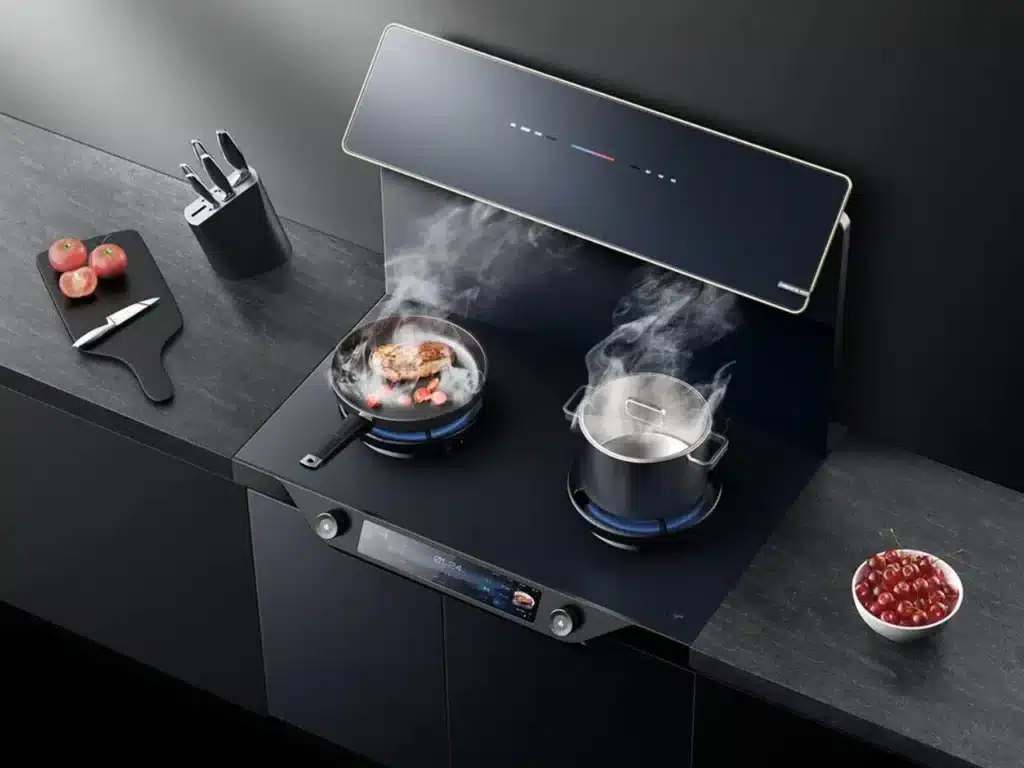 A smart cooking device built into the countertop, featuring a digital display and control buttons, with a dish in preparation and a glowing heat indicator.