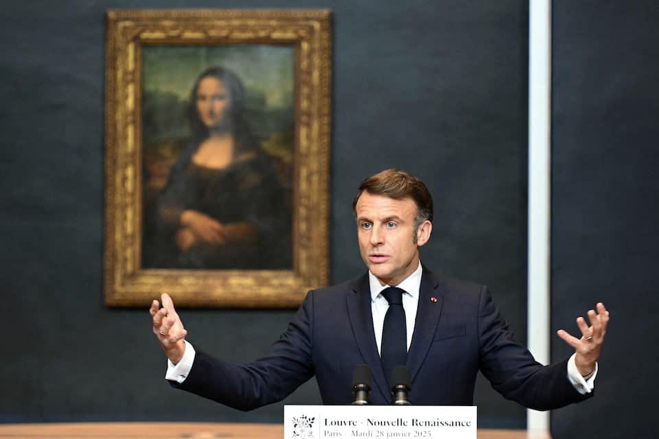 French President Emmanuel Macron speaks in front of the Mona Lisa at the Louvre Museum