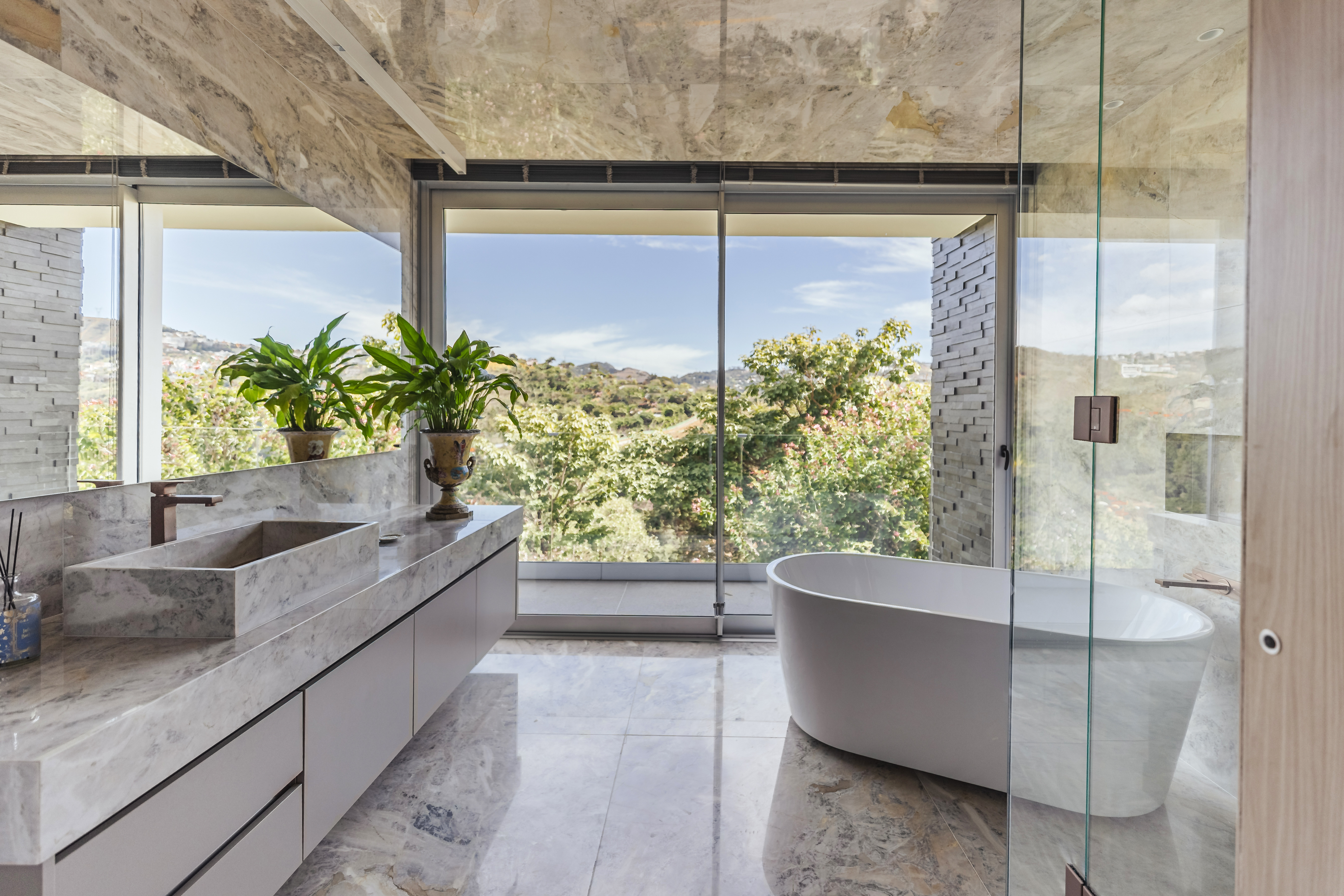 A marble bathroom adjoins the main bedroom