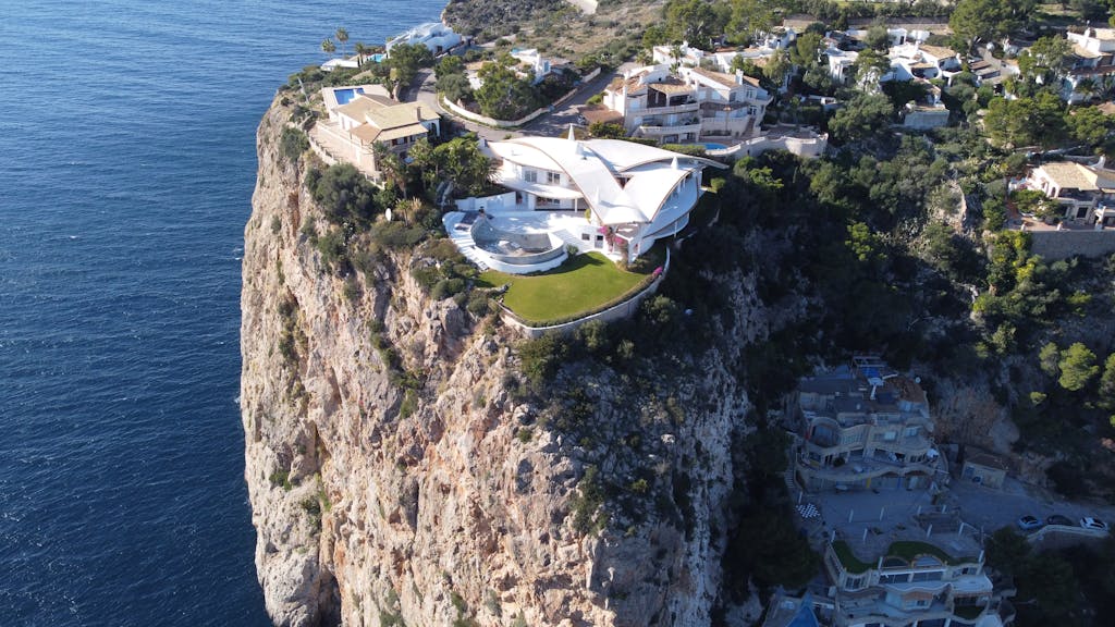 Aerial view of a luxurious clifftop villa in Port d’Andratx, Mallorca, Spain, offering breathtaking ocean views.