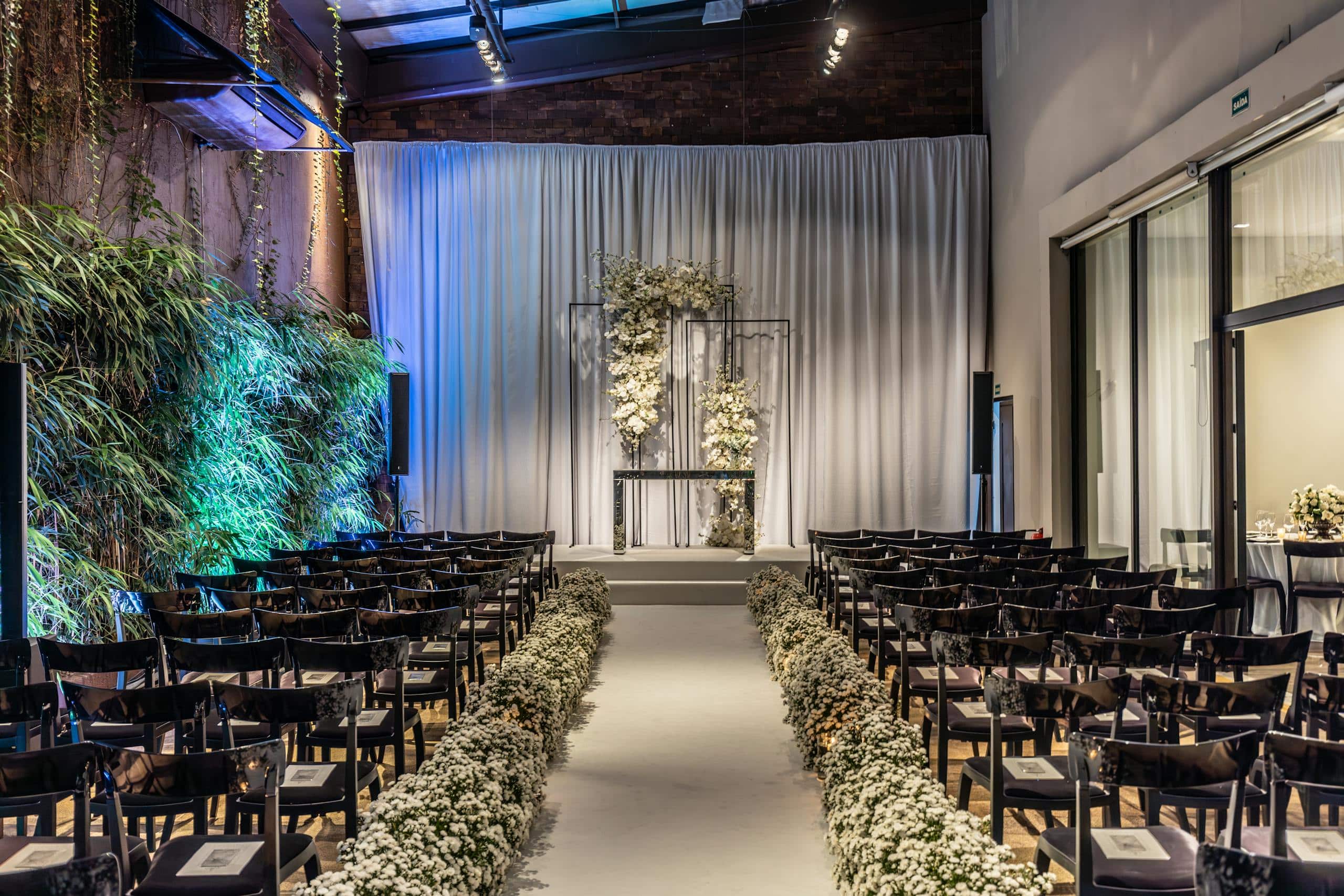 Beautifully decorated indoor wedding venue with elegant floral arrangements and seating.