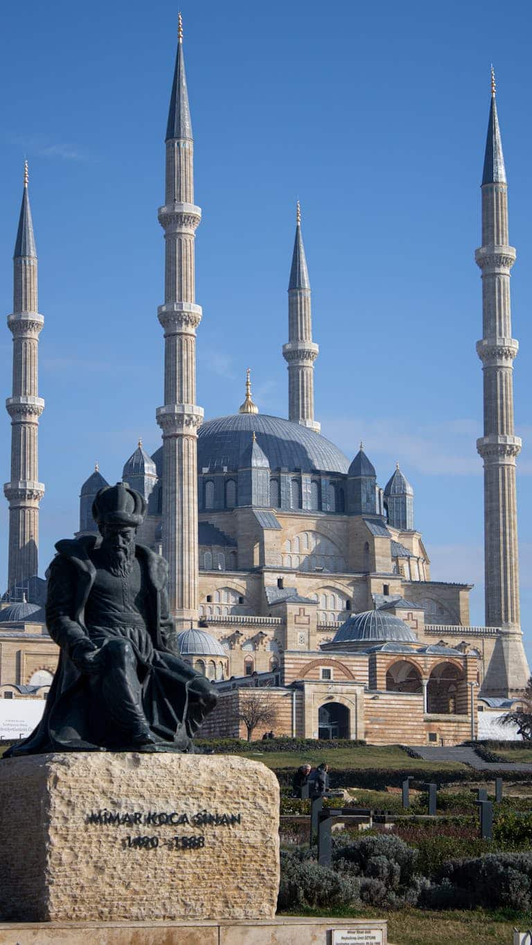 Captivating view of Selimiye Mosque with Mimar Sinan statue in Edirne, Türkiye.