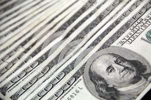 Detailed image showing a close-up of neatly stacked US dollar bills, ideal for financial and economic themes.