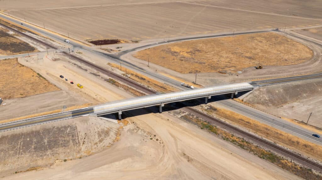 مشهد جوي من الطائرة بدون طيار يظهر معبر Avenue 88 الجديد، والذي يمتد فوق السكك الحديدية والطريق السريع.