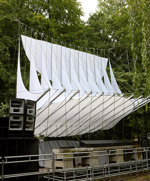 White textile canopy suspended over the Dekmantel stage, surrounded by trees in Amsterdamse Bos forest.