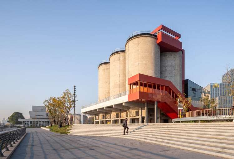 Industrial façade of former cement silos with striking orange staircases at GATE M West Bund Center in Shanghai
