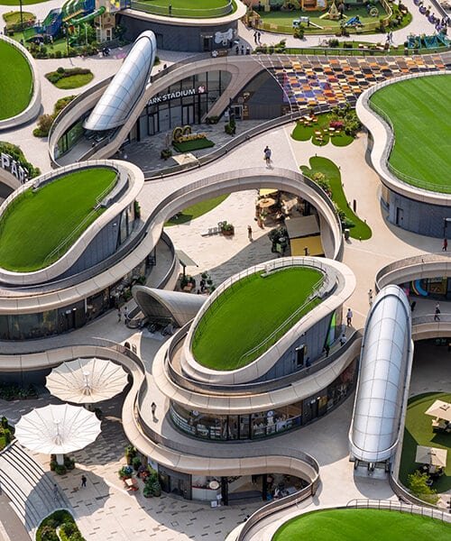 Aerial view of GO PARK Sai Sha showcasing rooftop terraces and layered green spaces above the sports park