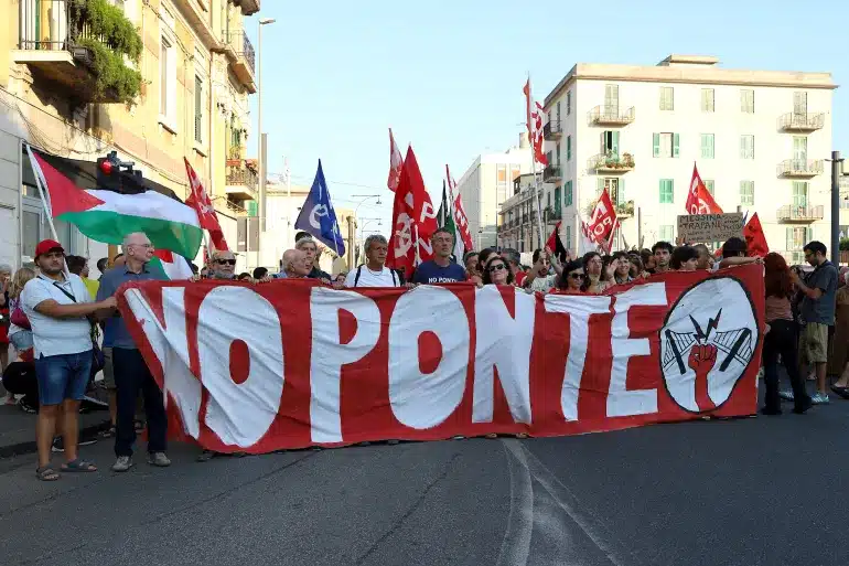  Protesters in Messina holding a large "NO PONTE" banner opposing the Messina Strait Bridge project.