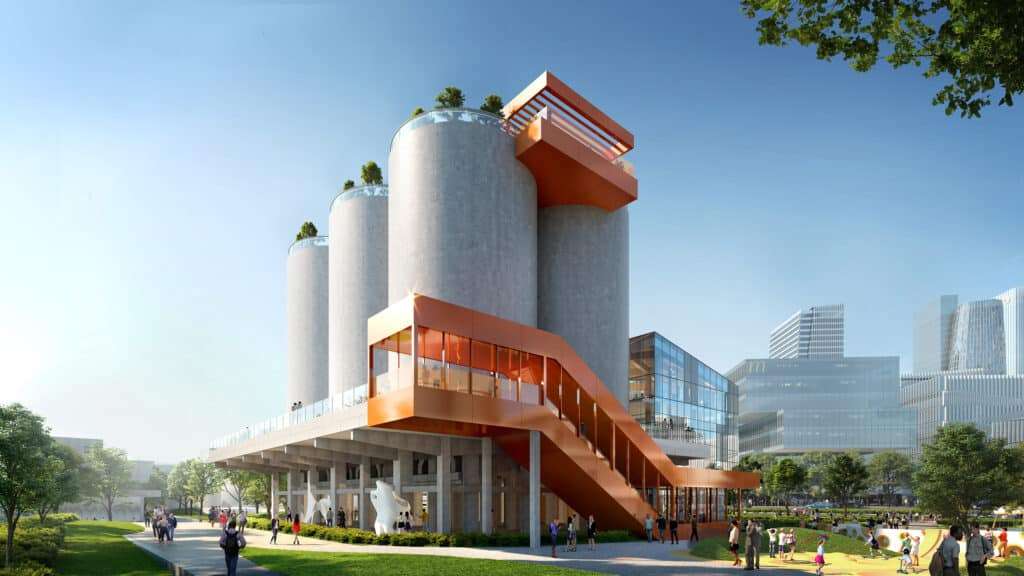 Exterior view of M Factory showing the adaptive reuse of industrial structure within a contemporary urban design