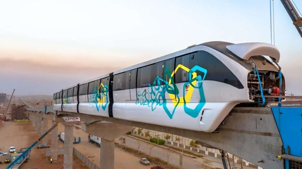 East Nile Monorail train traveling on elevated track with urban background