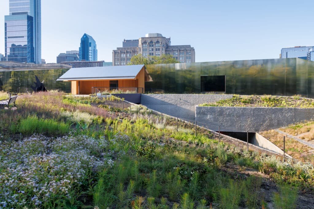 Metal facade of Calder Gardens Museum with surrounding gardens.