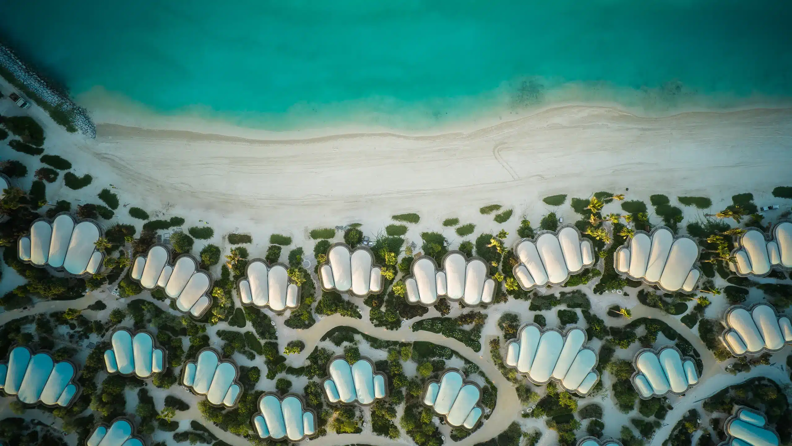 Aerial view of JLL’s new “Live JLL” project in Saudi Arabia, showcasing buildings and green spaces.