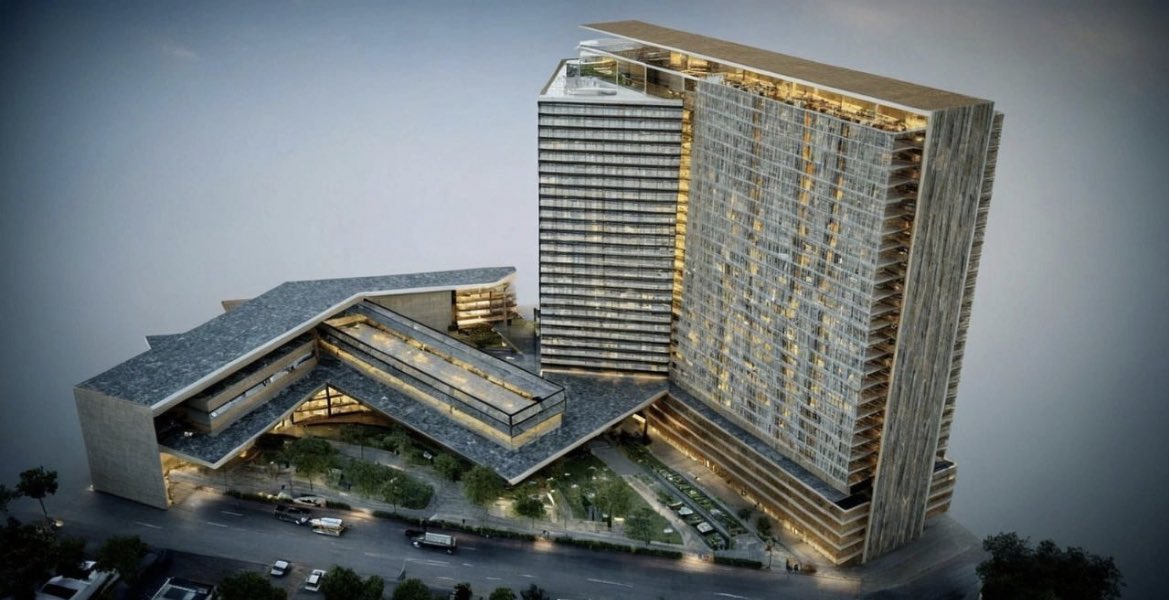 منظور نهاري لمبنى بوليفارد أحد رفيدة يوضح الواجهة الزجاجية والتكوين العمراني على الطريق الرئيسي