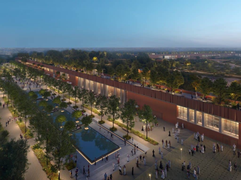 منظر أرضي لمسارات المشي ومساحات التشجير في حديقة العروبة أثناء ضوء النهار.