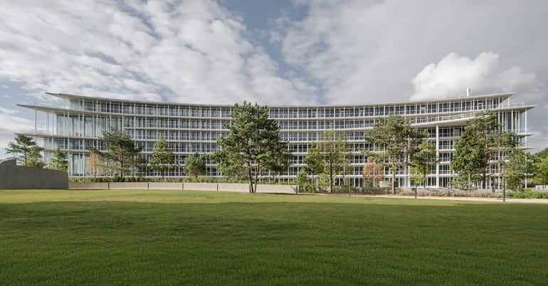 Side view of Lombard Odier headquarters showing extended concrete slabs and exterior terraces.
