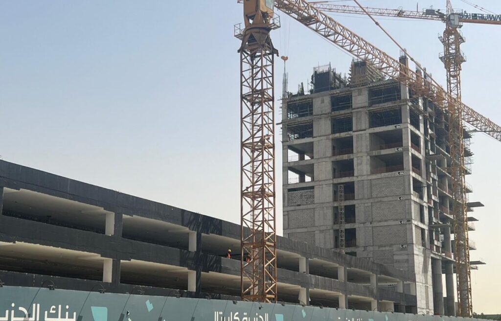 Construction progress at the site, with a crane visible.