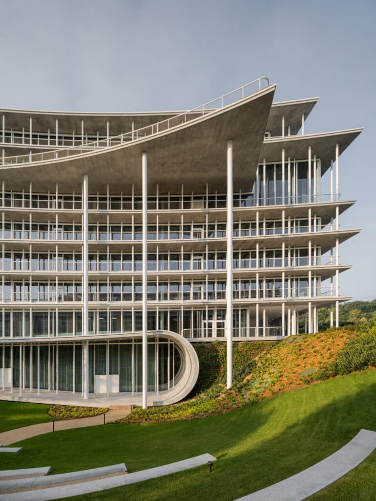 Main entrance of Lombard Odier headquarters with white columns and transparent glass façades.