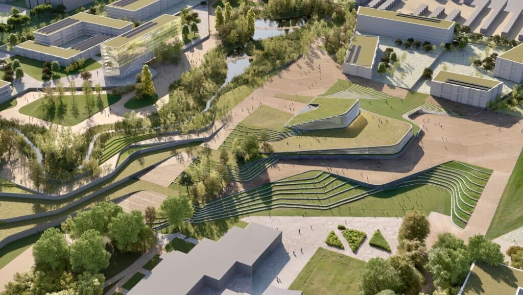 Aerial view of DAT Alierta: green rooftops, winding paths, and terraced parks blending nature with modern buildings.