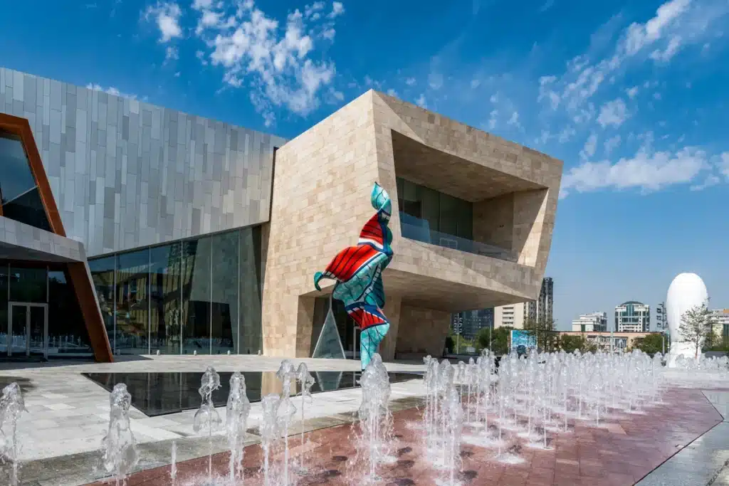 Facade of the Almaty Museum of Arts combining natural stone and aluminum