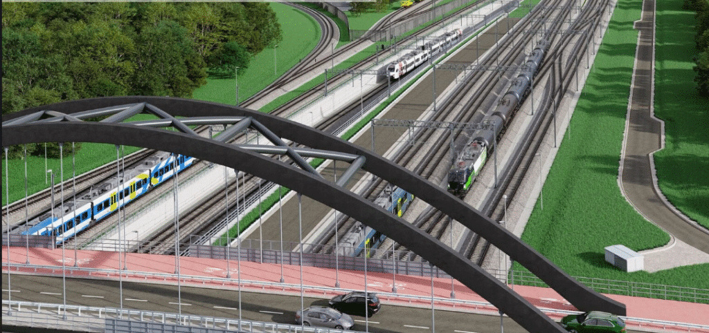 A 3D rendering of the Maksymilianowo railway modernization project, showing a curved bridge connecting roads and railway tracks, with passenger trains in blue and yellow, freight trains on multiple tracks, and a road running beneath the structure.