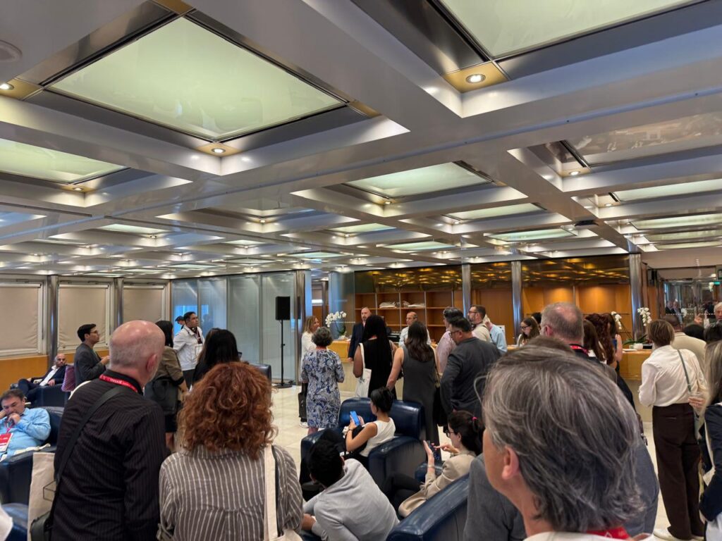 Architects and designers gathering inside an exhibition booth at Cersaie 2025 in Bologna