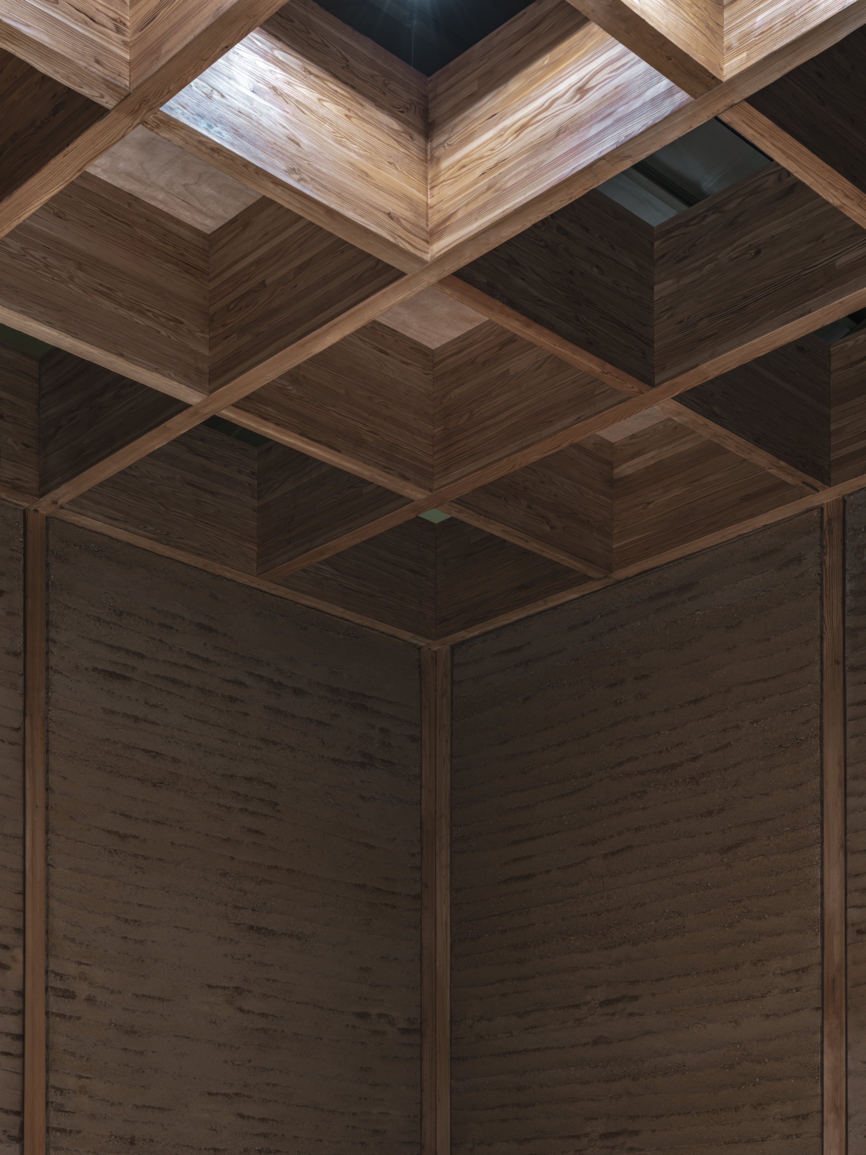 Bangjja Yugi Museum interiors featuring earth built walls and timber details
