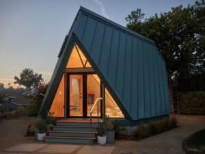 Tetra-One origami-inspired home exterior in La Jolla backyard, reflecting California sunlight