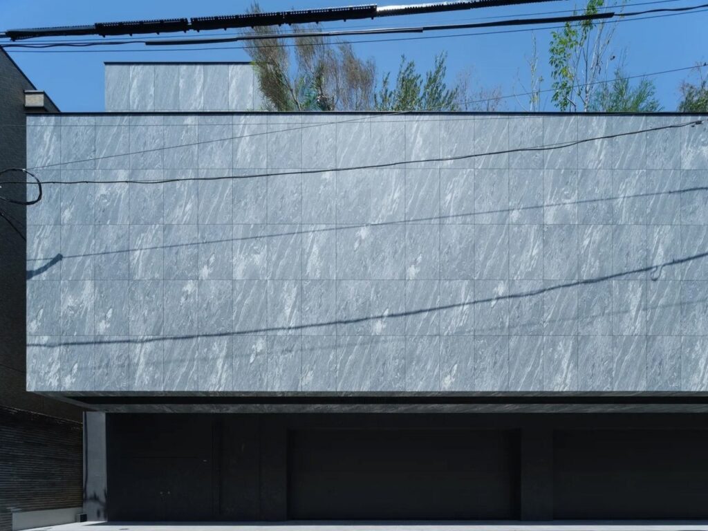 Exterior view of the Hidden House in Minato, Tokyo, showing a solid concrete facade.