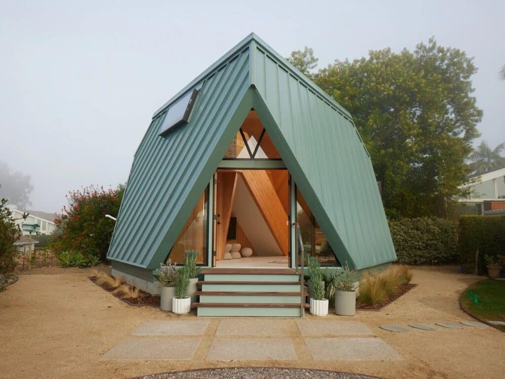 Tetra-One origami-inspired home exterior in La Jolla backyard, reflecting California sunlight