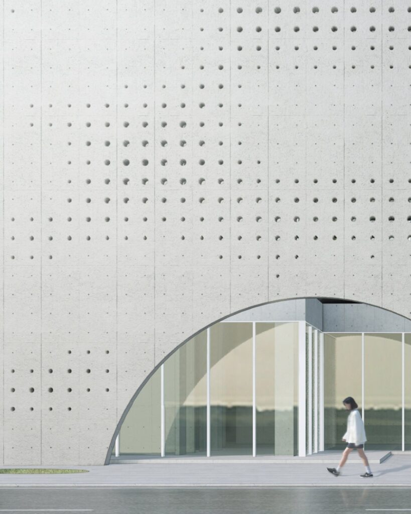 Arched opening at ground level framing a public square and side garden of the building.