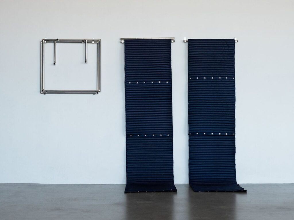 Silver buttons used to secure cushions on Roll-up Chair