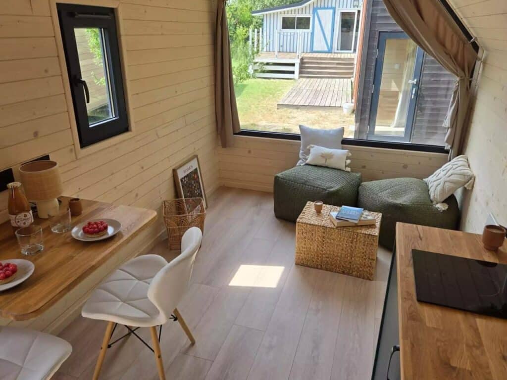 Open living area in Nid Luxe with a daybed, built-in storage, and natural lighting