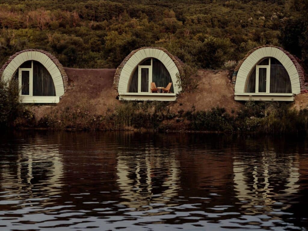 Grassy mounds with panoramic windows overlooking the lake