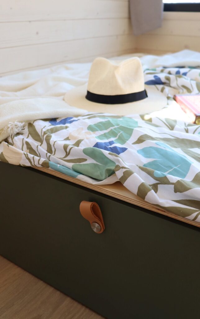 Open living area in Nid Luxe with a daybed, built-in storage, and natural lighting