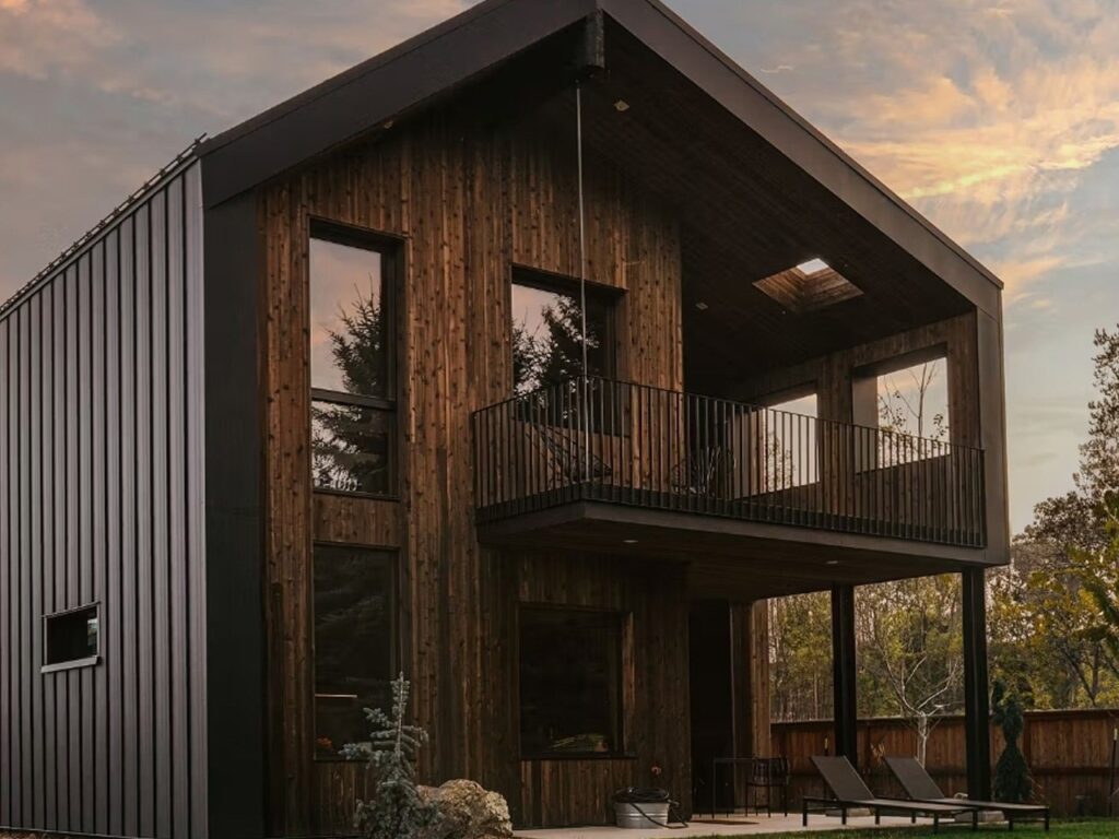 Side view of Freya House showing integration of Scandinavian design with surrounding nature