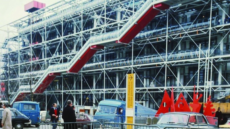 Vintage photo of Centre Pompidou with 90s cars and people.