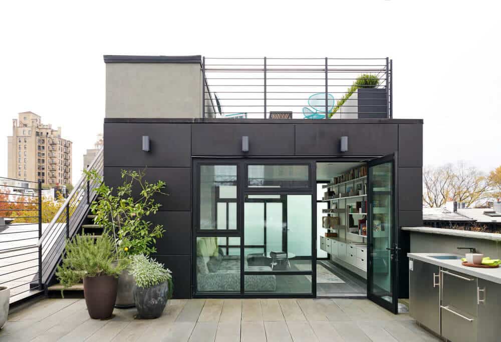Exterior view of the Park Slope house showing the historic facade and modern metal additions