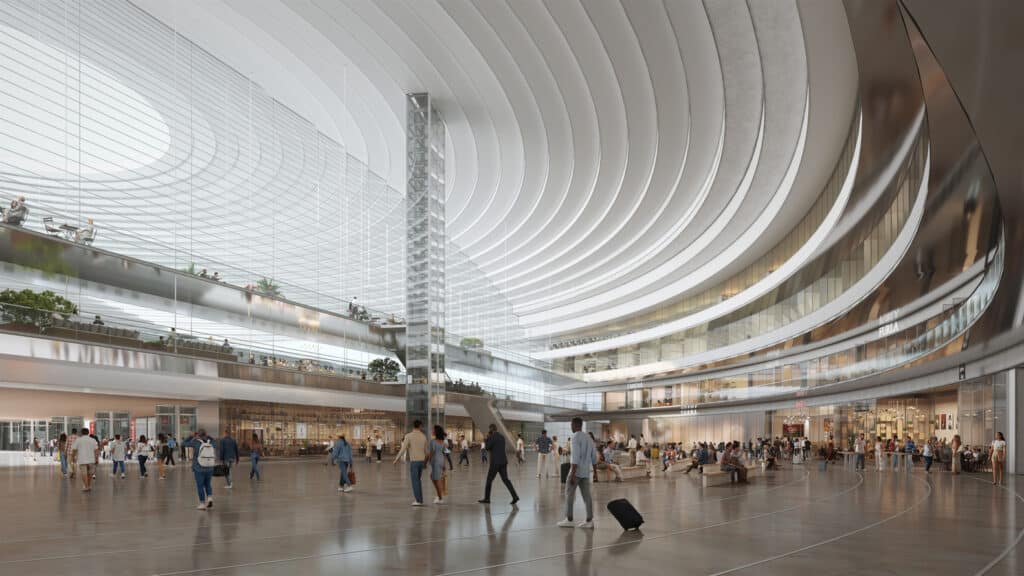 The grand interior of Casablanca&rsquo;s new Casa Sud Train Station, featuring a soaring curved ceiling, multi-level walkways with shops and cafes, and bustling travelers moving through the bright, open concourse.