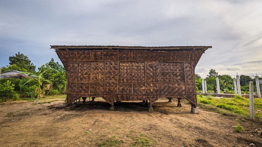 A low-cost, earthquake-resistant bamboo home raised on stilts in Mandalay, Myanmar — built with woven panels and modular frames for rapid assembly and family customization.