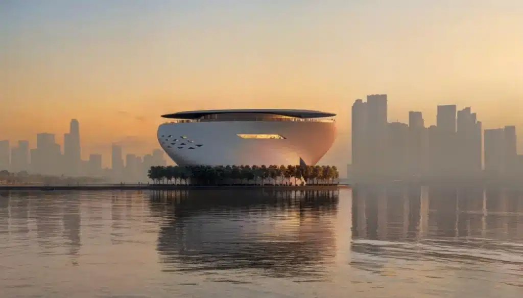 Twisting façade of the Dubai Museum of Art along Dubai Creek, featuring triangular windows ascending with the building’s white curves.