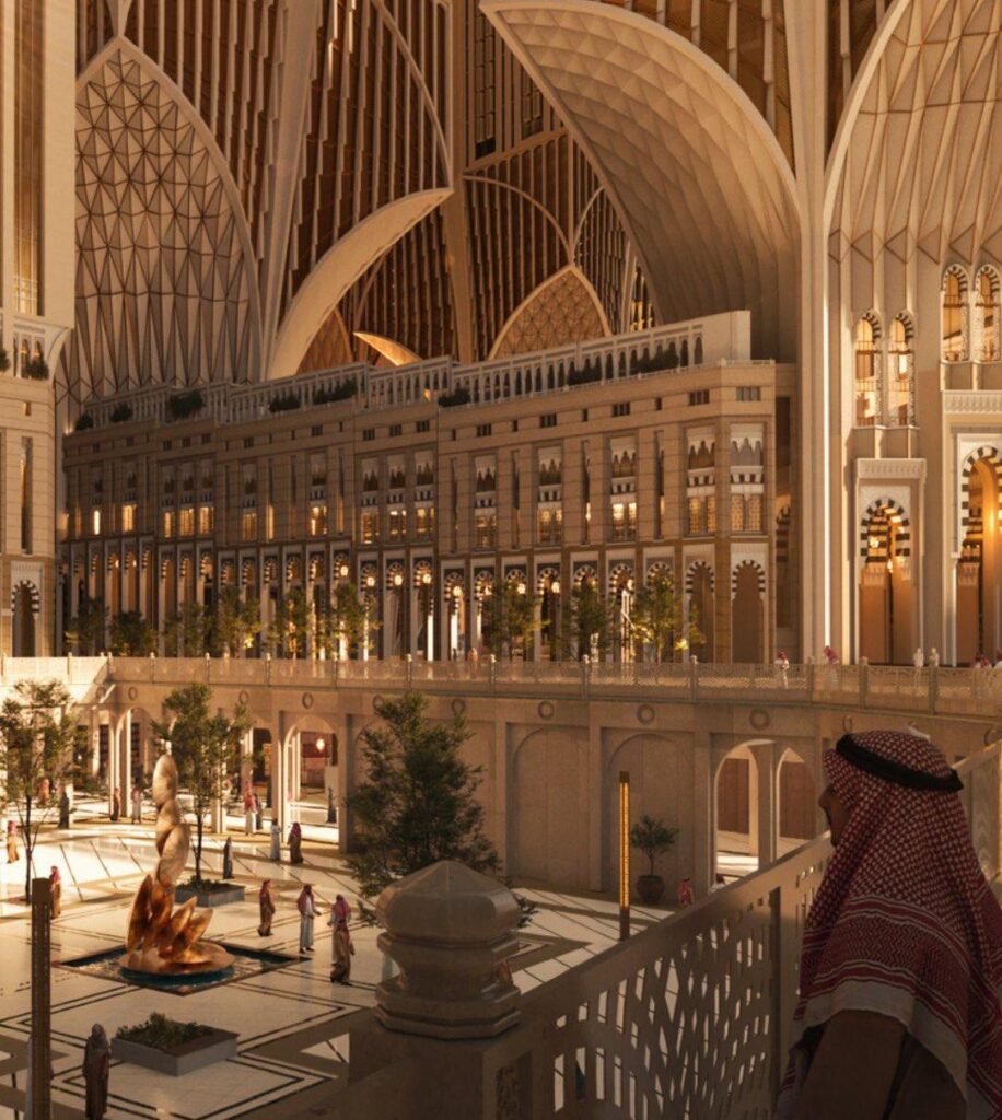 Alt: A grand interior view of a new urban development near the Grand Mosque in Makkah, showcasing Islamic-inspired architecture blended with modern design, featuring open courtyards and soaring arches that reflect the city&rsquo;s sacred atmosphere.